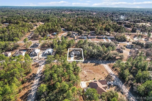 bird's eye view featuring a forest view and a residential view