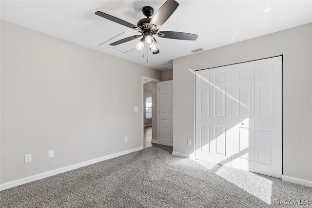 unfurnished bedroom featuring visible vents, baseboards, a ceiling fan, light colored carpet, and a closet