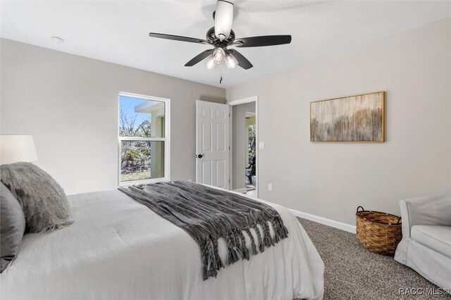 carpeted bedroom with a ceiling fan and baseboards