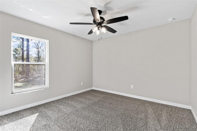 empty room with ceiling fan, carpet, and baseboards