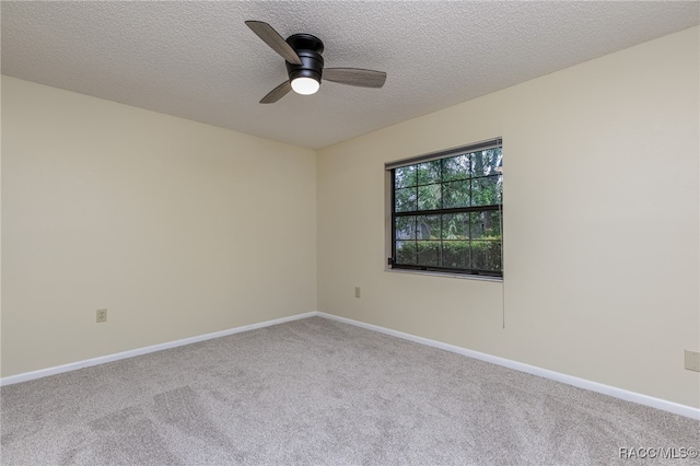 spare room featuring carpet, a textured ceiling, and ceiling fan