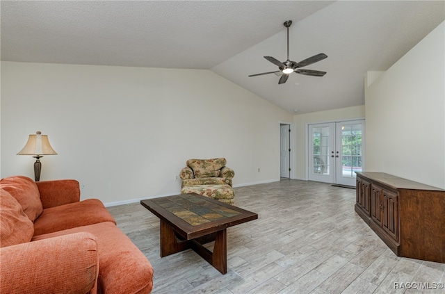 living room with french doors, light hardwood / wood-style flooring, vaulted ceiling, and ceiling fan