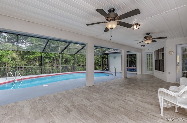 view of pool featuring glass enclosure and a patio area