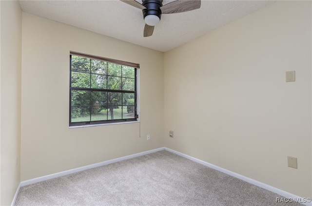 empty room with a textured ceiling, carpet floors, and ceiling fan