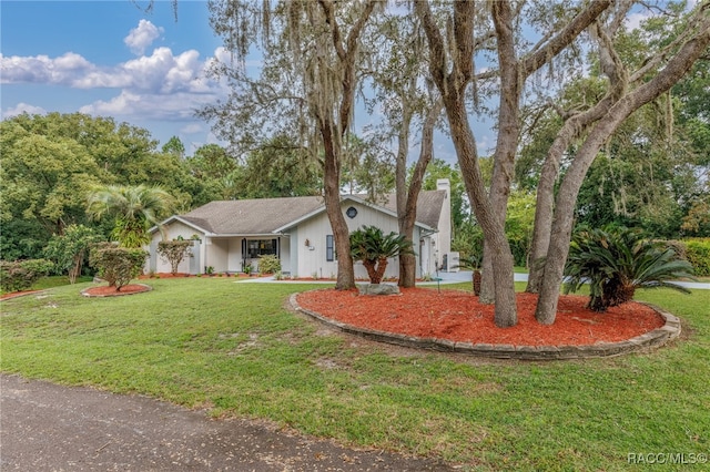 ranch-style home featuring a front yard