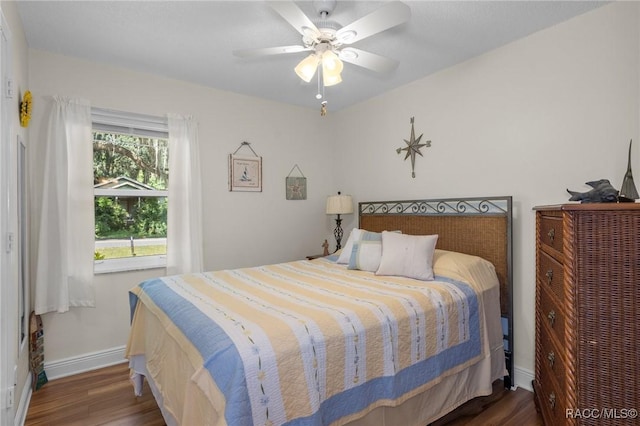 bedroom with dark wood-type flooring and ceiling fan