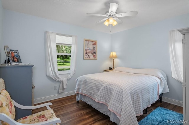 bedroom with dark hardwood / wood-style flooring and ceiling fan