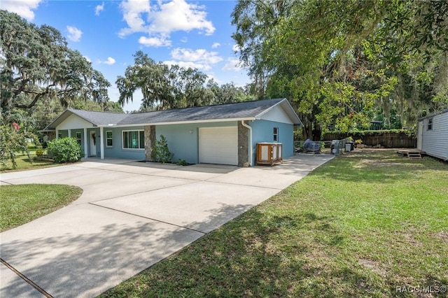 single story home with a garage and a front lawn