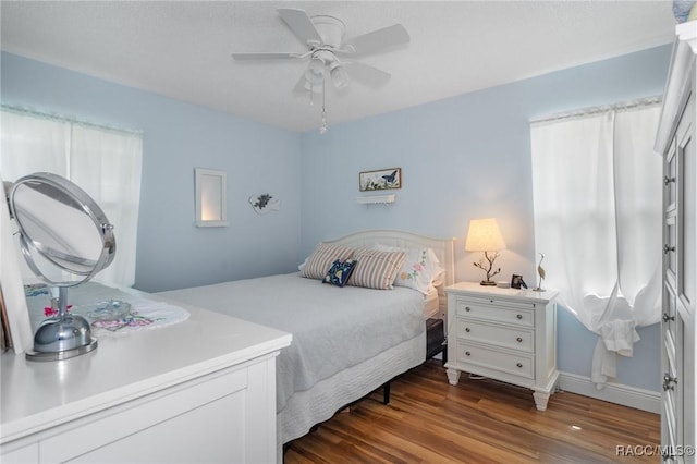 bedroom featuring dark wood-type flooring and ceiling fan