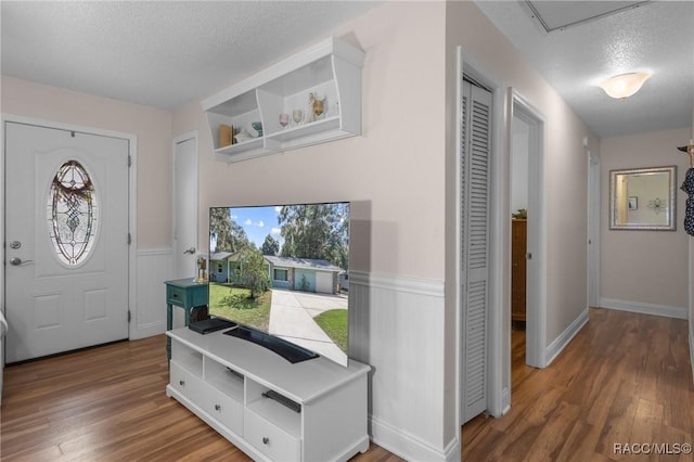 entrance foyer featuring hardwood / wood-style floors and a textured ceiling