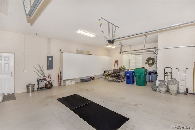 garage with electric panel and a garage door opener