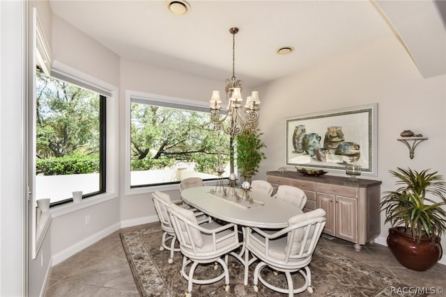 tiled dining space featuring a chandelier