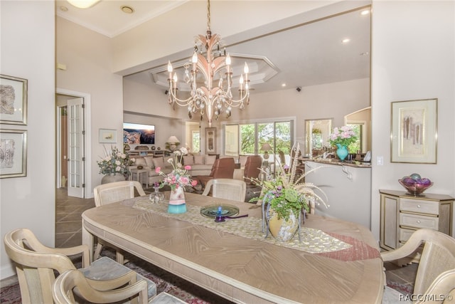 dining space featuring ornamental molding and an inviting chandelier