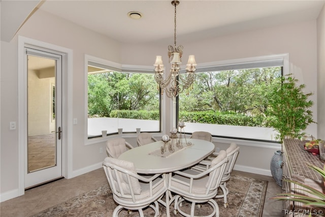 dining space featuring tile patterned flooring and a chandelier