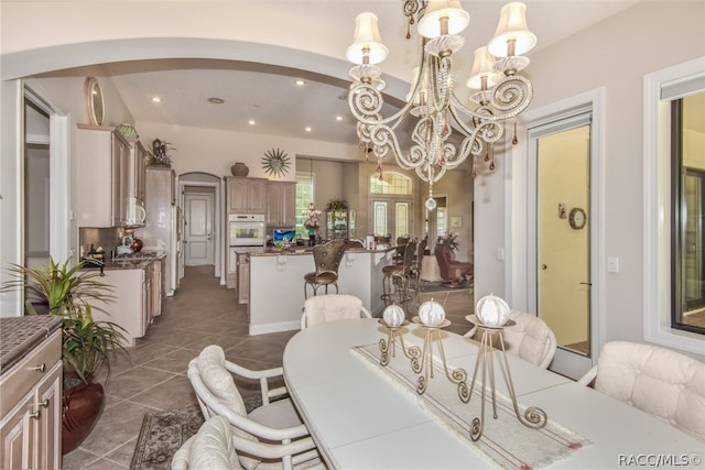 dining space with a notable chandelier and dark tile patterned floors