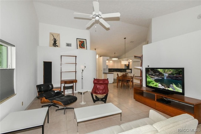 tiled living room with ceiling fan and high vaulted ceiling