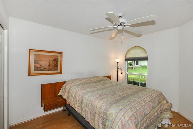 bedroom with ceiling fan and wood-type flooring