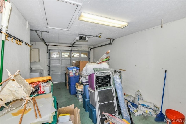 garage with a garage door opener and washer and clothes dryer