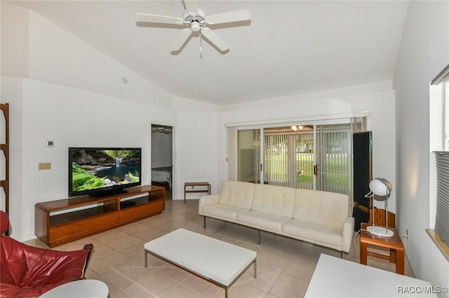 living room with ceiling fan, light tile patterned floors, and lofted ceiling