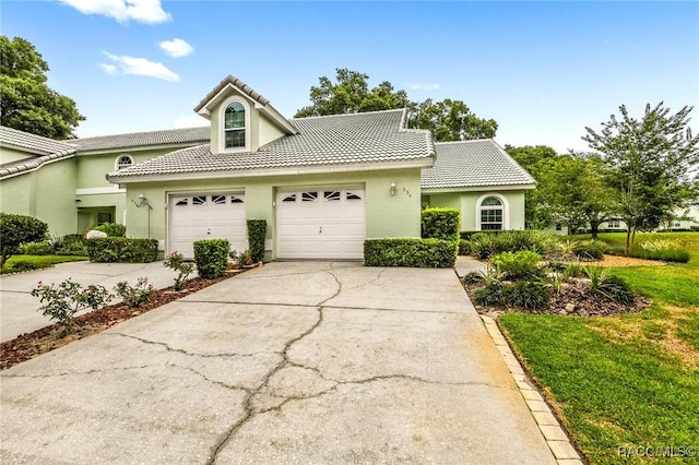 view of front facade with a front yard and a garage