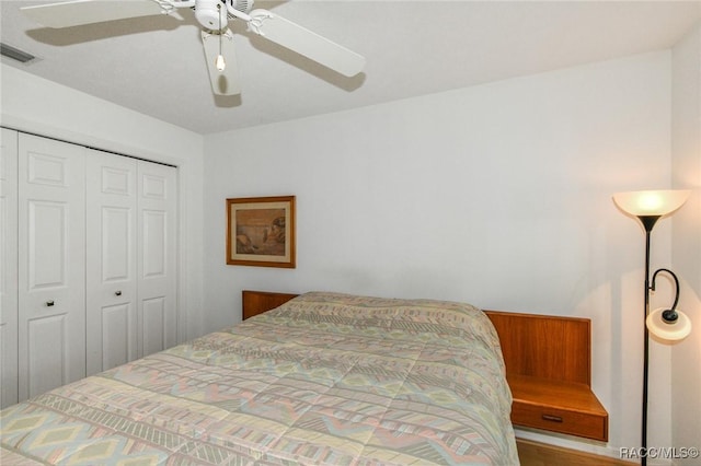 bedroom with ceiling fan and a closet