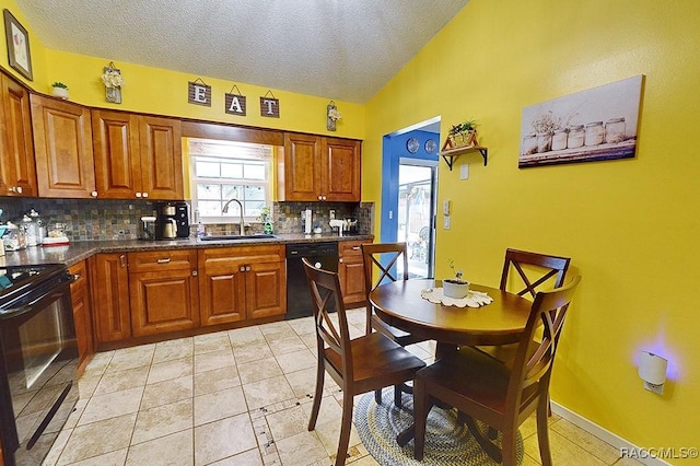 kitchen featuring tasteful backsplash, sink, black appliances, and a textured ceiling