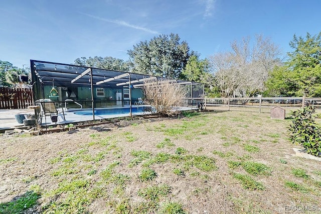 view of yard with a lanai and a fenced in pool