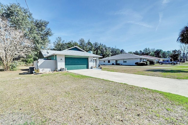 ranch-style house featuring a garage and a front yard