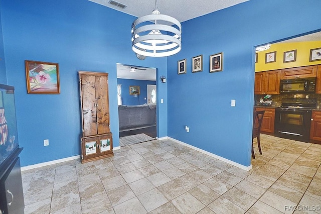 interior space featuring ceiling fan with notable chandelier and light tile patterned floors