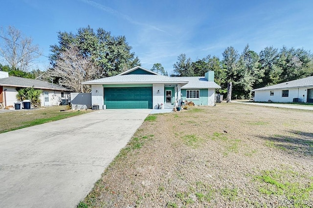 ranch-style house featuring a garage and a front lawn