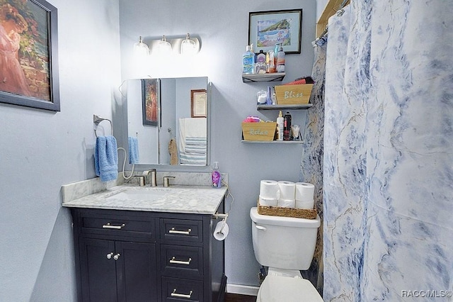 bathroom with vanity, a shower with curtain, and toilet