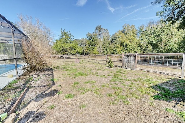 view of yard with glass enclosure