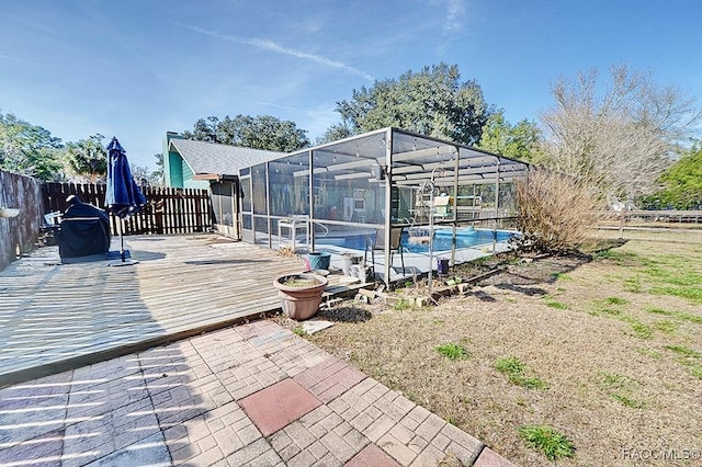 view of swimming pool featuring a patio and a lanai