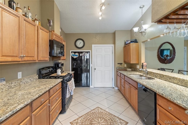 kitchen with sink, black appliances, pendant lighting, light tile patterned floors, and a chandelier