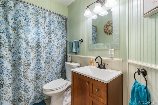 bathroom with vanity, curtained shower, and toilet