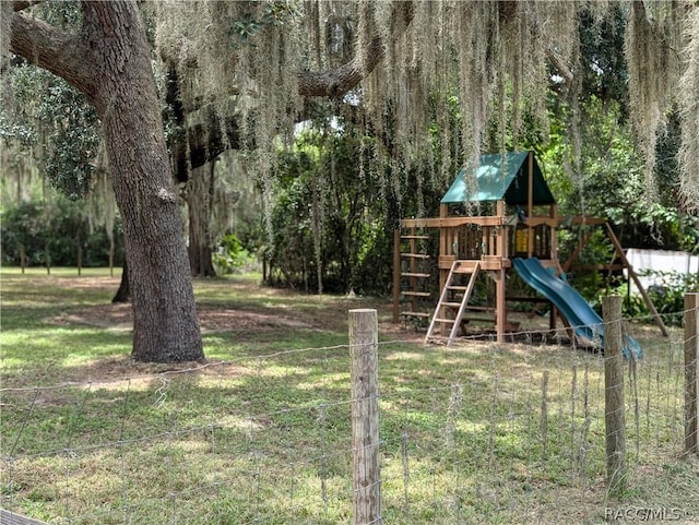 view of playground featuring a view of trees