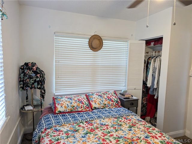 bedroom featuring multiple windows, a closet, and ceiling fan