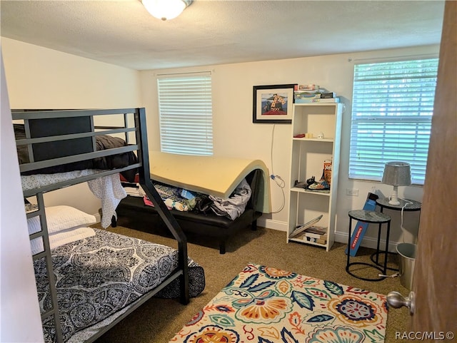 carpeted bedroom with a textured ceiling