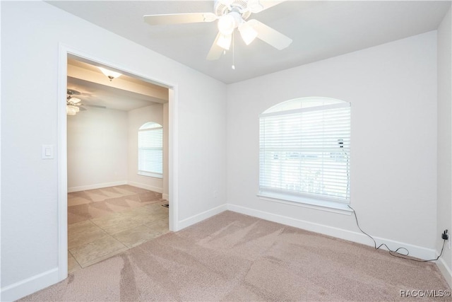 carpeted spare room with ceiling fan and a healthy amount of sunlight