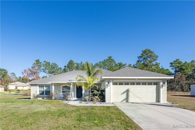 ranch-style house featuring a porch, a garage, and a front yard