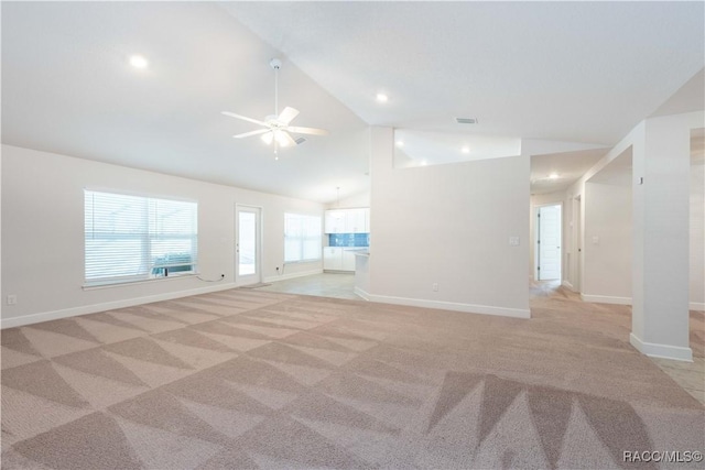 unfurnished living room featuring ceiling fan, light colored carpet, and lofted ceiling