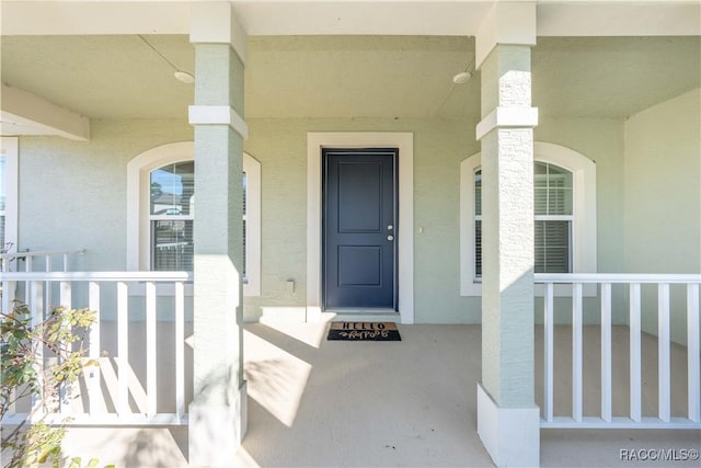 view of exterior entry featuring a porch