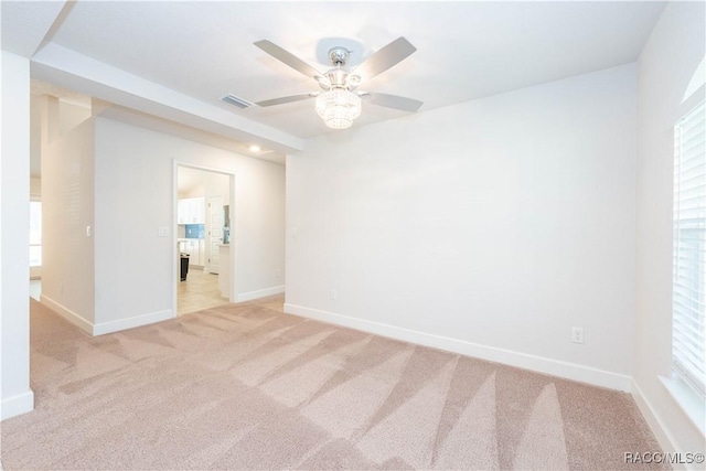 spare room with ceiling fan and light colored carpet