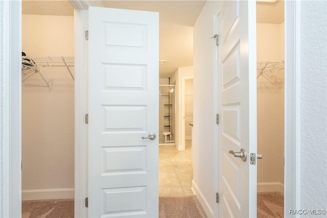 spacious closet with light tile patterned floors