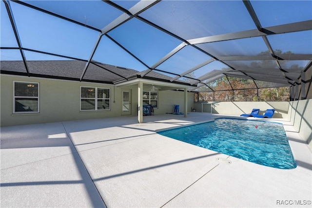 view of swimming pool with a lanai, a patio area, and ceiling fan