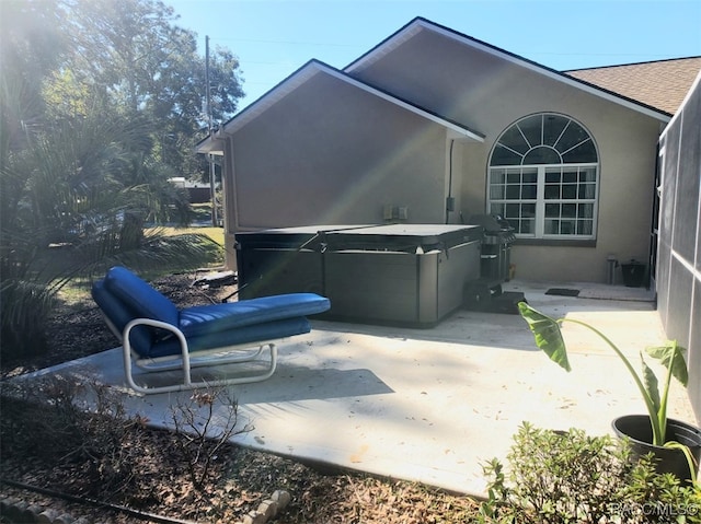 view of patio / terrace with grilling area and a hot tub