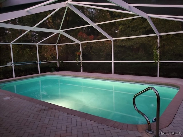 view of pool with glass enclosure