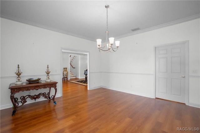 9093 E Pinehurst Ct, Inverness, FL 34450 - unfurnished room featuring ornamental molding, stairway, a chandelier, and wood finished floors