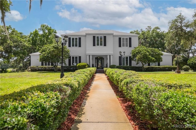 9093 E Pinehurst Ct, Inverness, FL 34450 - view of front facade featuring a front lawn
