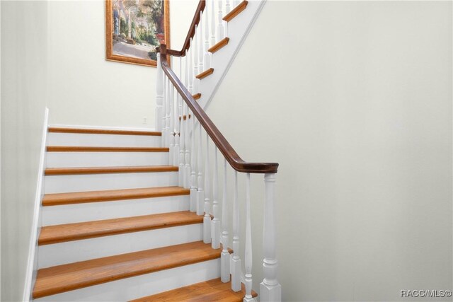 9093 E Pinehurst Ct, Inverness, FL 34450 - staircase featuring wood finished floors